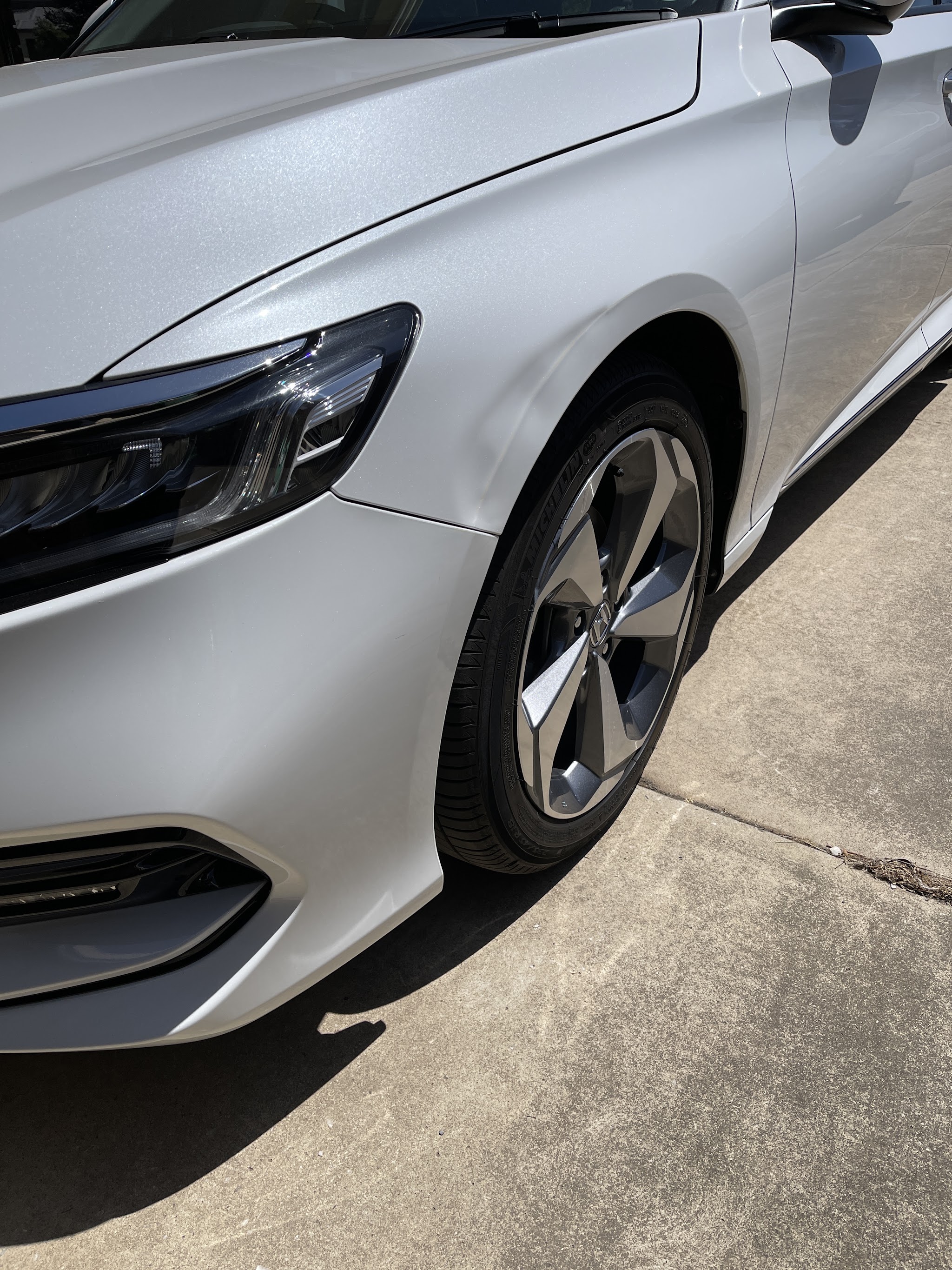 The same white Honda with the front guard back to a clean, straight line